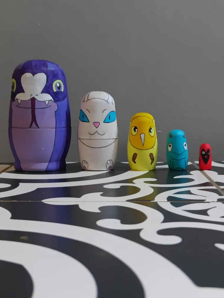 Nesting dolls painted as Owl House characters.