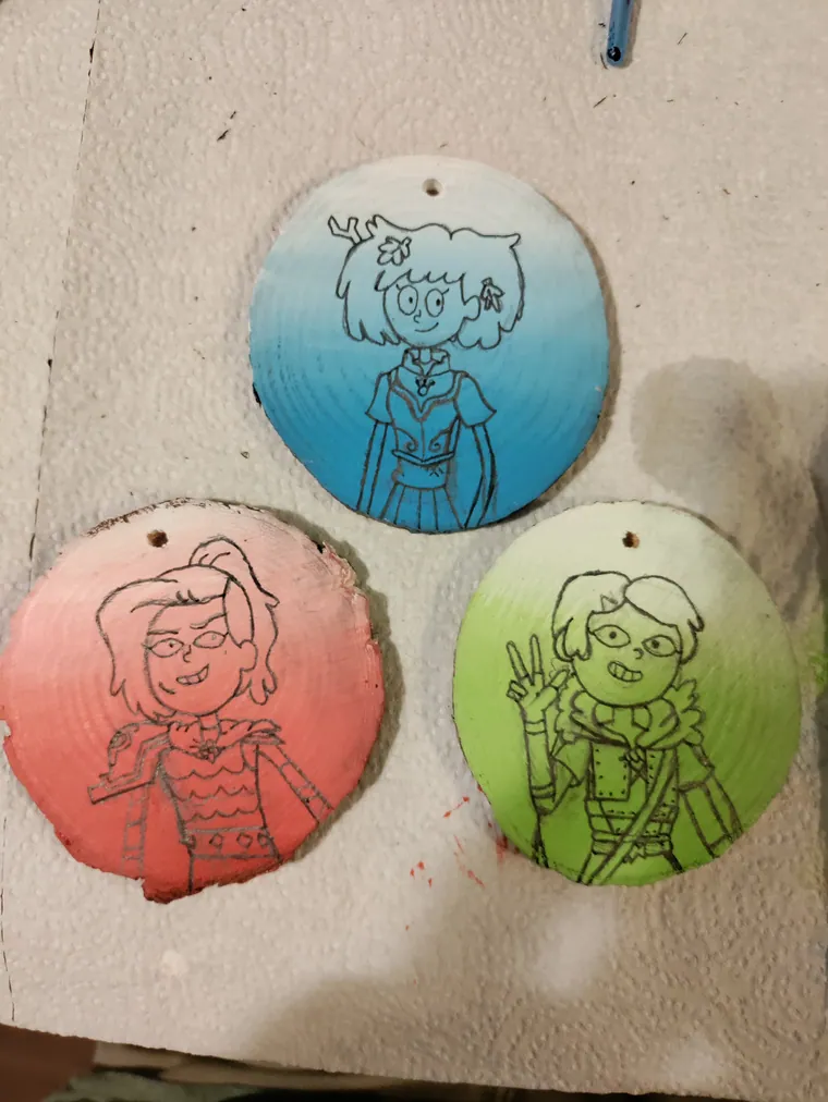 Three wood slices drying after a first colour pass.