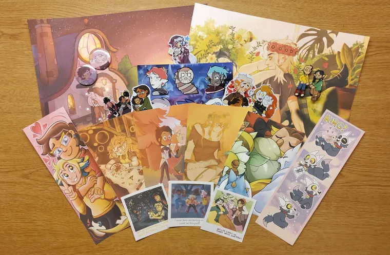Prints, sticker sheets and polaroids laid out.