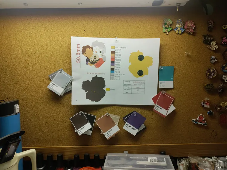 Proofing board with Pantone chips, ink pads and pin samples pinned up.