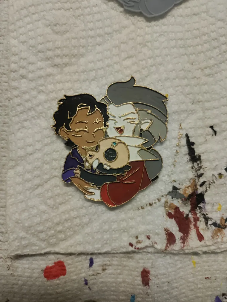 Finished pin beside the paint used to check it.