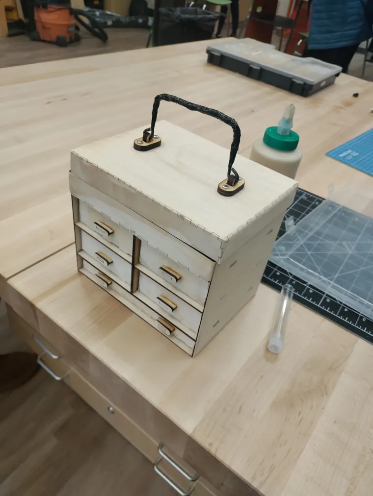 The finished chest with drawers and a handle.